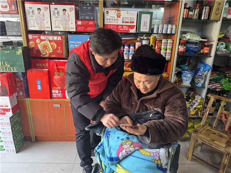 普法志愿者深入农村指导客户观看普法视频